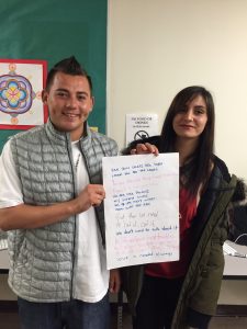 Beyza & Cesar with the poem they worked on at the poetry workshop.